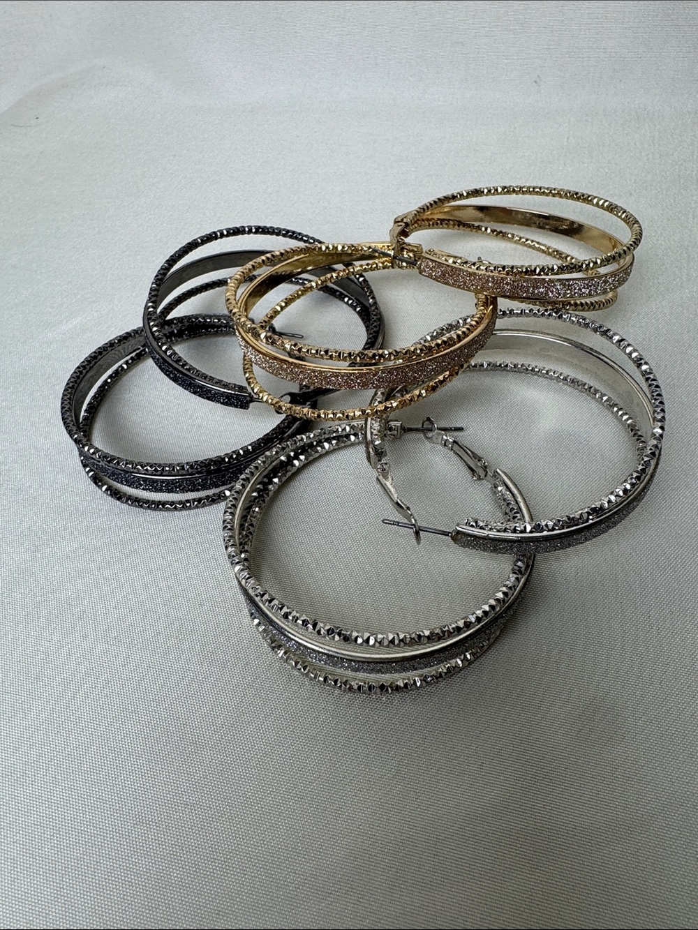 Bundle of Sparkly Multi-Tone Hoop Earrings in Gold, Silver, and Black